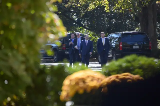 Trump aide Dan Scavino(L) and other members of President-elect Donald Trump's staff outside White House