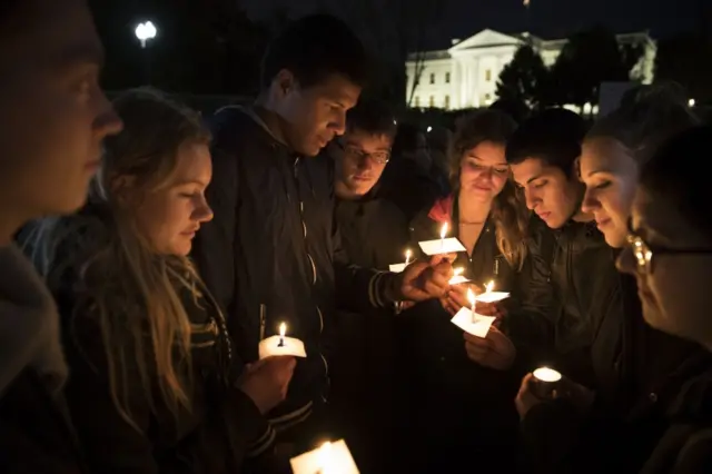 People gather for an anti-Donald Trump candlelight vigil in front of the White House