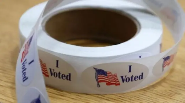 A roll of I Voted stickers sits on a table at Oakman Elementary School during the US presidential election on November 8, 2016 in Dearborn, Michigan