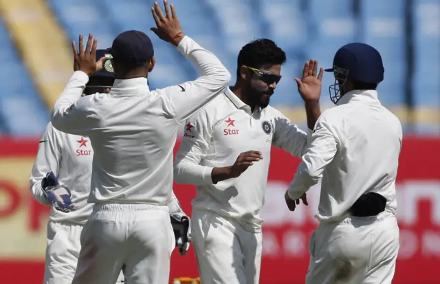 India's players celebrate the wicket of Chris Woakes