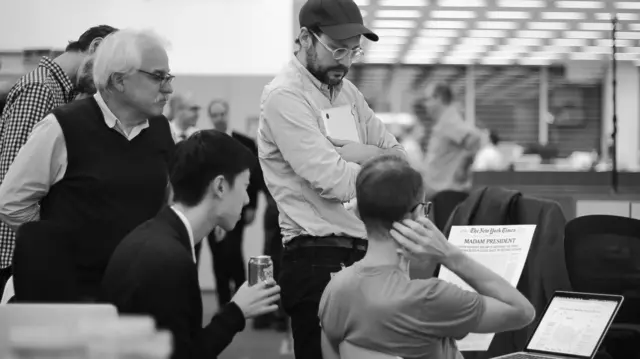 Picture shows NYT staff reviewing front page it hoped to print on Wednesday, with the headline "Madam President"