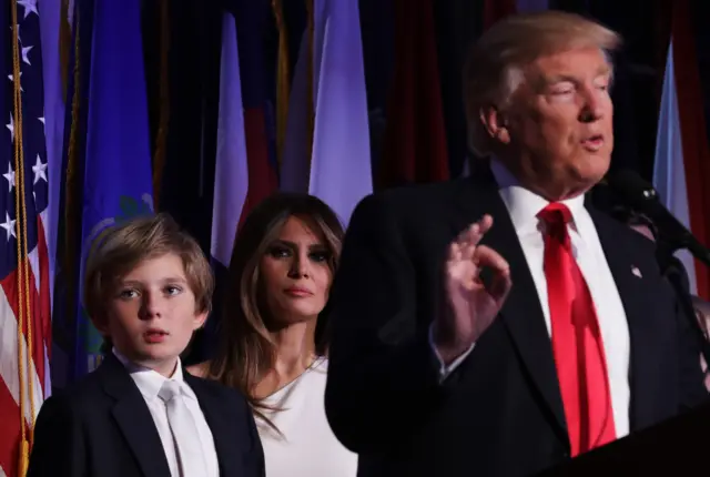 Barron Trump and Melania Trump stand next to Donald Trump as he delivers his victory speech