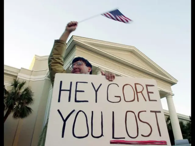 huck Gallion of Tallahassee, Fla., carries a message and waves an American flag outside the Florida Supreme Court