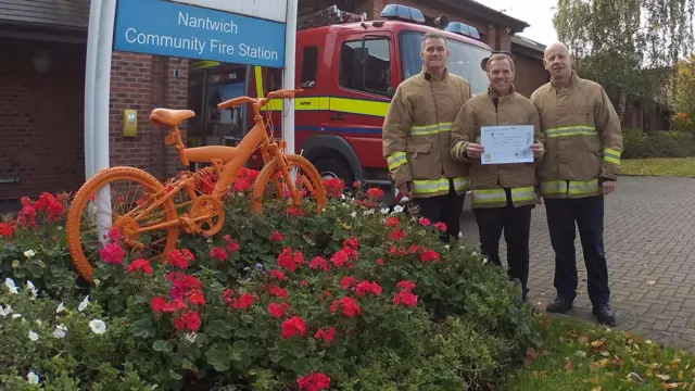 Nantwich firefighters outside celebrating their Britain in Bloom award