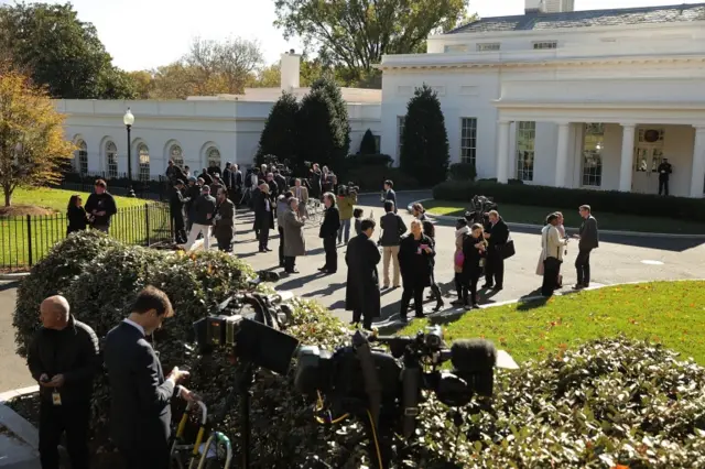 People wait outside White House