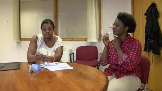 Woman taking swab HIV test