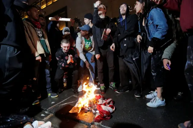 Protesters burn American flag outside the Trump Tower in New York