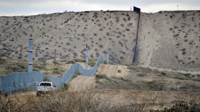 A US Border Patrol agent drives near the US-Mexico border fence in Sunland Park, New Mexico - Jan. 4, 2016