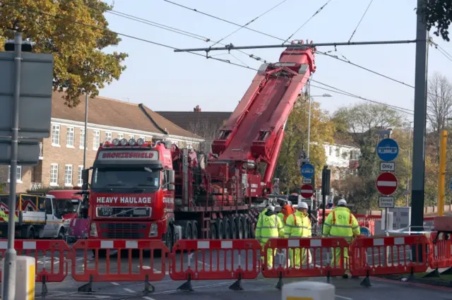 A crane is raised into position at the scene near the tram crash in Croyd