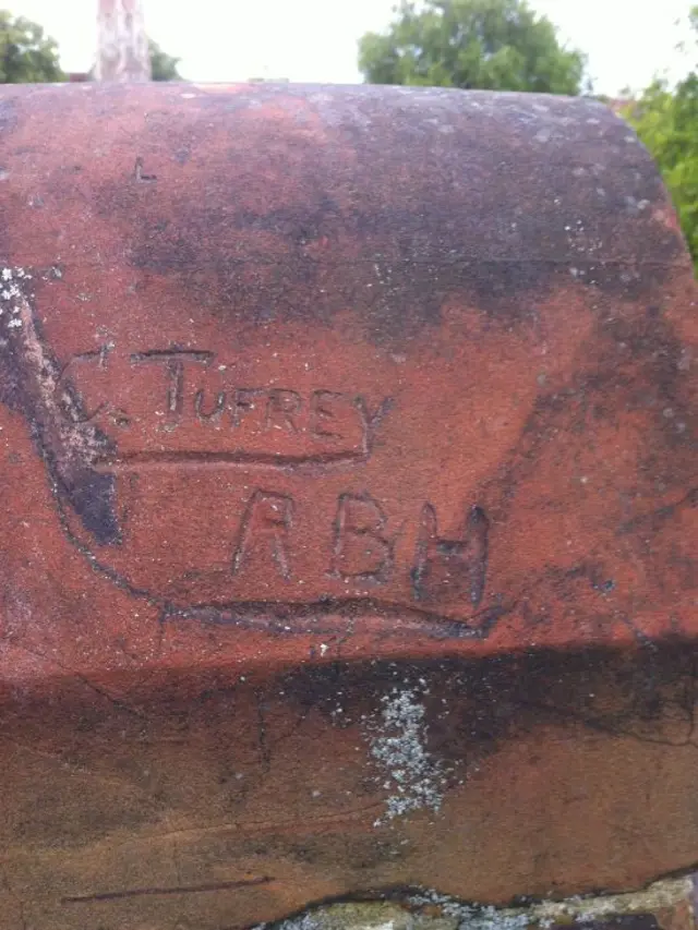 The name of Tufrey scratched into brickwork