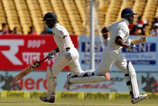 India's Cheteshwar Pujara (L) and Murali Vijay