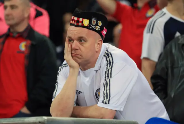 A Scotland fan appears dejected
