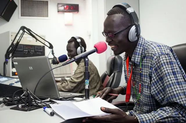 South Sudanese hip hop artist LUAL (R) jams live at Eye Radio, next to journalist Daniel Danis, in Juba, South Sudan, on March 16, 2014.