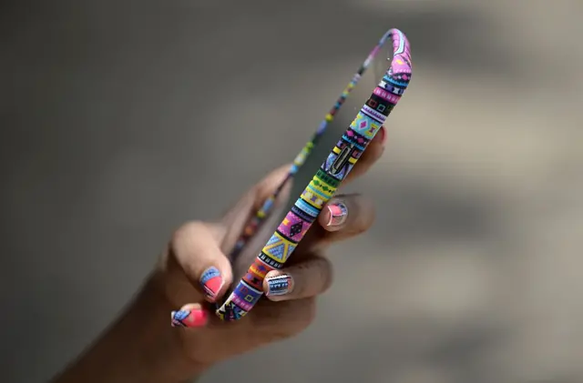 A student checks her phone.