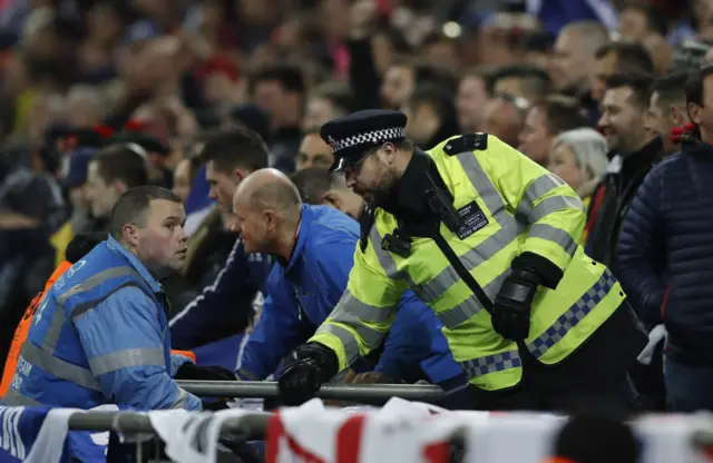 A police officer talks to a steward