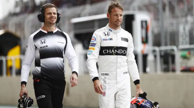 Jenson Button walks down the pitlane