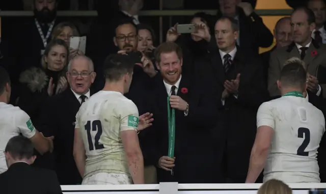 Owen Farrell receives a medal from Britain's Prince Harry