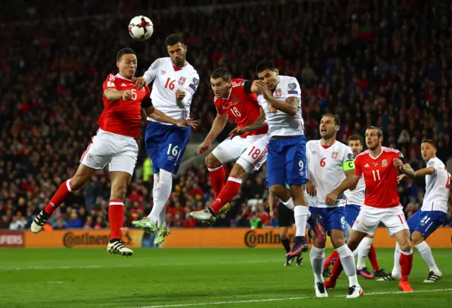 James Chester of Wales competes in the air with Luka Milivojevic of Serbia