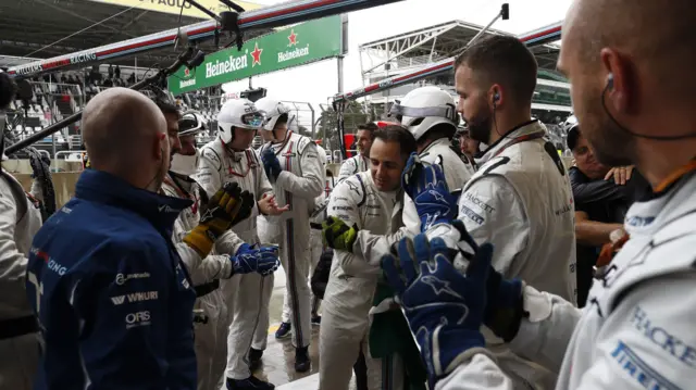 Massa greeted by the team in the pits