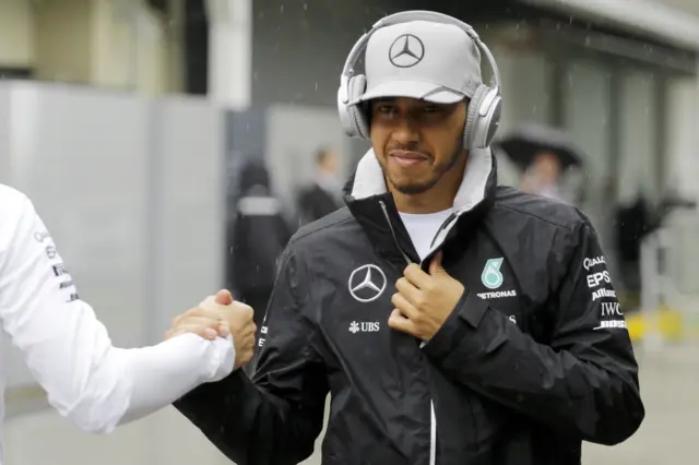 Lewis Hamilton arrives in the rain