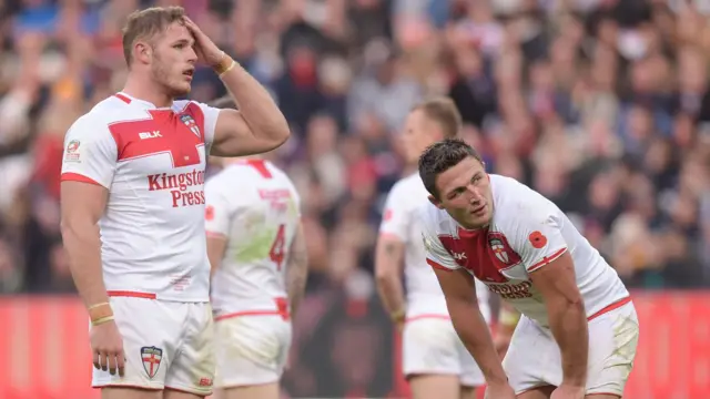 Tom Burgess and Sam Burgess of England look dejected