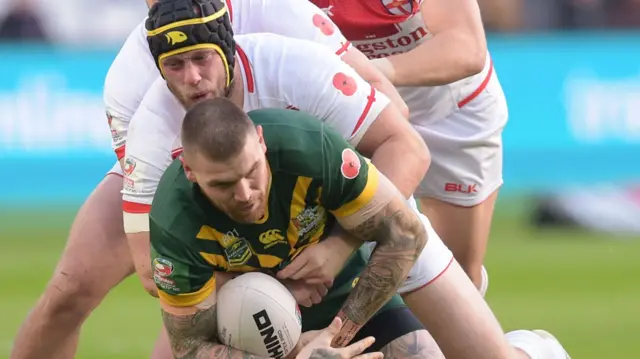 Chris Hill of England tackles Josh Dugan of Australia