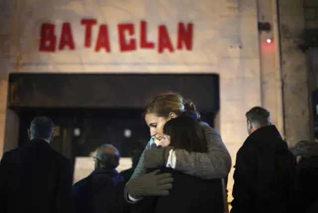 Mourners gather outside the Bataclan on the anniversary of the shootings