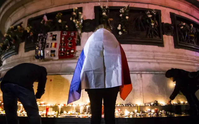 People pay their respects on the anniversary of the Paris attacks