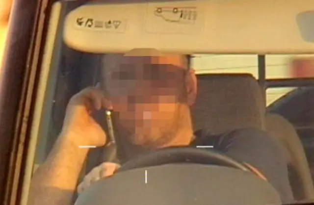 Man on phone driving