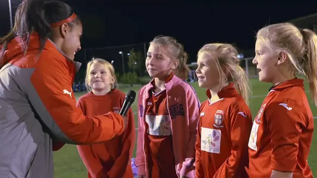 Alex Scott interviewing four aspiring young footballers