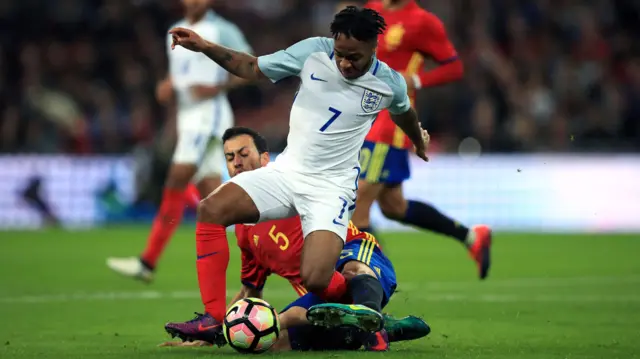 Sergio Busquets challenges Raheem Sterling