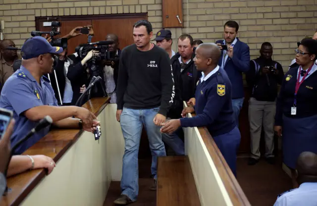 suspects enter court