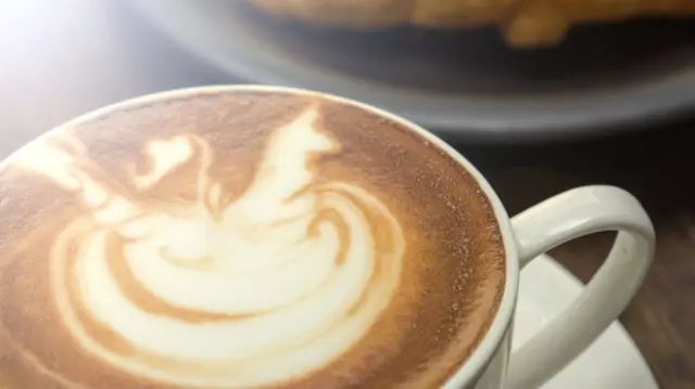 Cup of frothy coffee seen from above