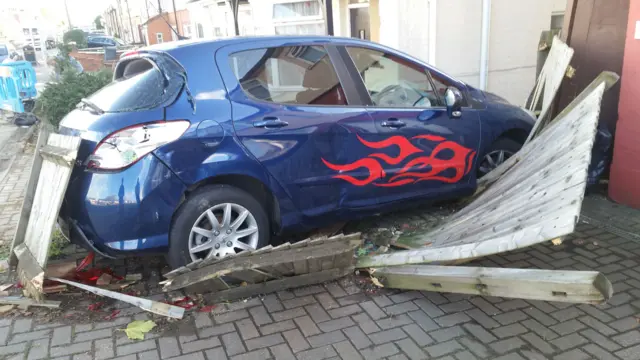 car and fence damaged on driveway