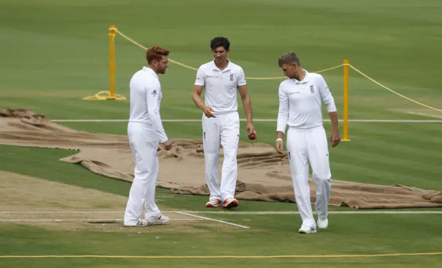 Jonny Bairstow, left, Zafar Ansari, cenre, and Joe Root check out the pitch