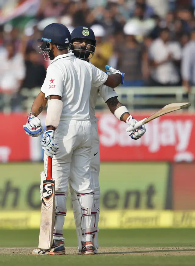 Kohli and Pujara hug