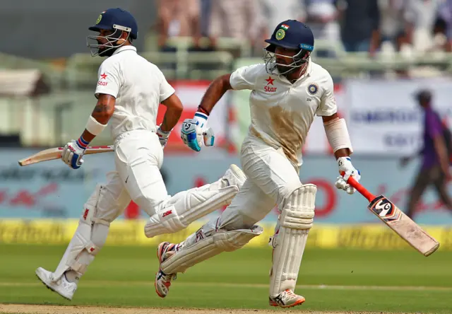 Virat Kohli and Cheteshwar Pujara run between the wickets