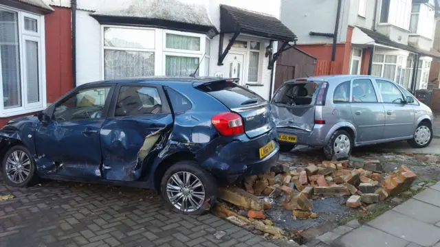 Two damaged cars on driveway