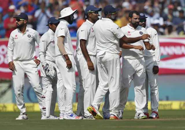 India celebrate the dismissal of England captain Alastair Cook