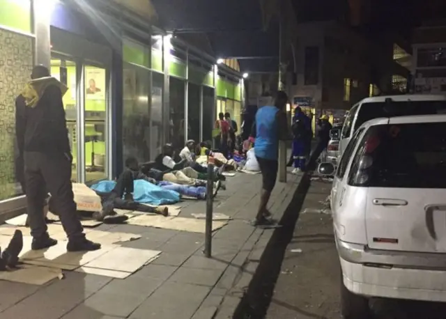 People outside a bank in Harare