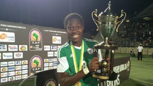 Asisat Oshoala with the Women's Africa Cup of Nations trophy after Nigeria won the title in 2014