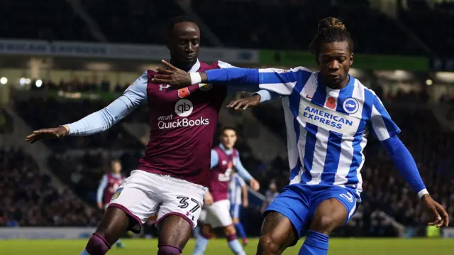 Albert Adomah of Aston Villa and Gaetan Bong of Brighton & Hove Albion