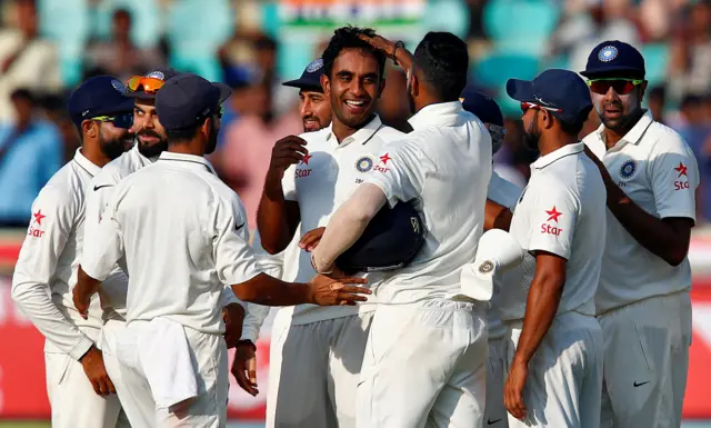 India's Jayant Yadav celebrates with his teammate