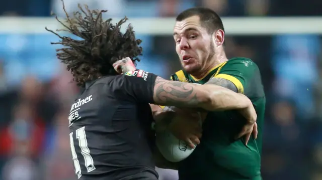 Australia's David Klemmer is tackled by New Zealand's Kevin Proctor