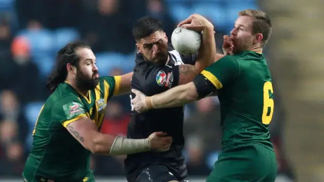 New Zealand's Jess Bromwich is tackled by Australia's Aaron Woods and Michael Morgan