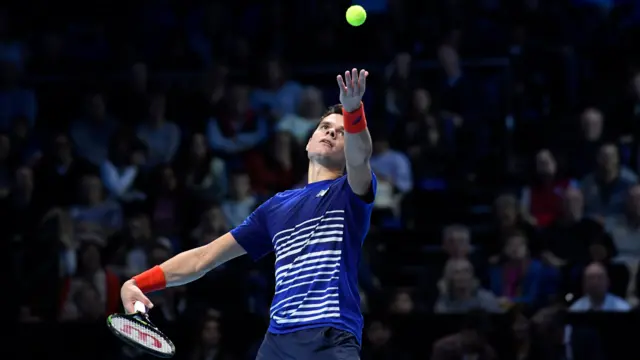 Milos Raonic serves