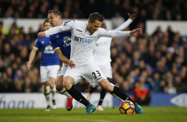 Phil Jagielka challenges Gylfi Sigurdsson