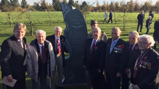 Guinea Pig Club group alongside monument