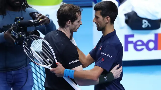 Murray and Djokovic embrace at the end of the match