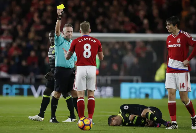 Adam Clayton is shown a yellow card